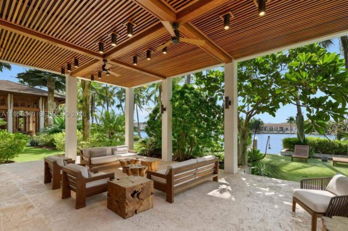 An outdoor seating area looks out over the estate’s waterfront access.