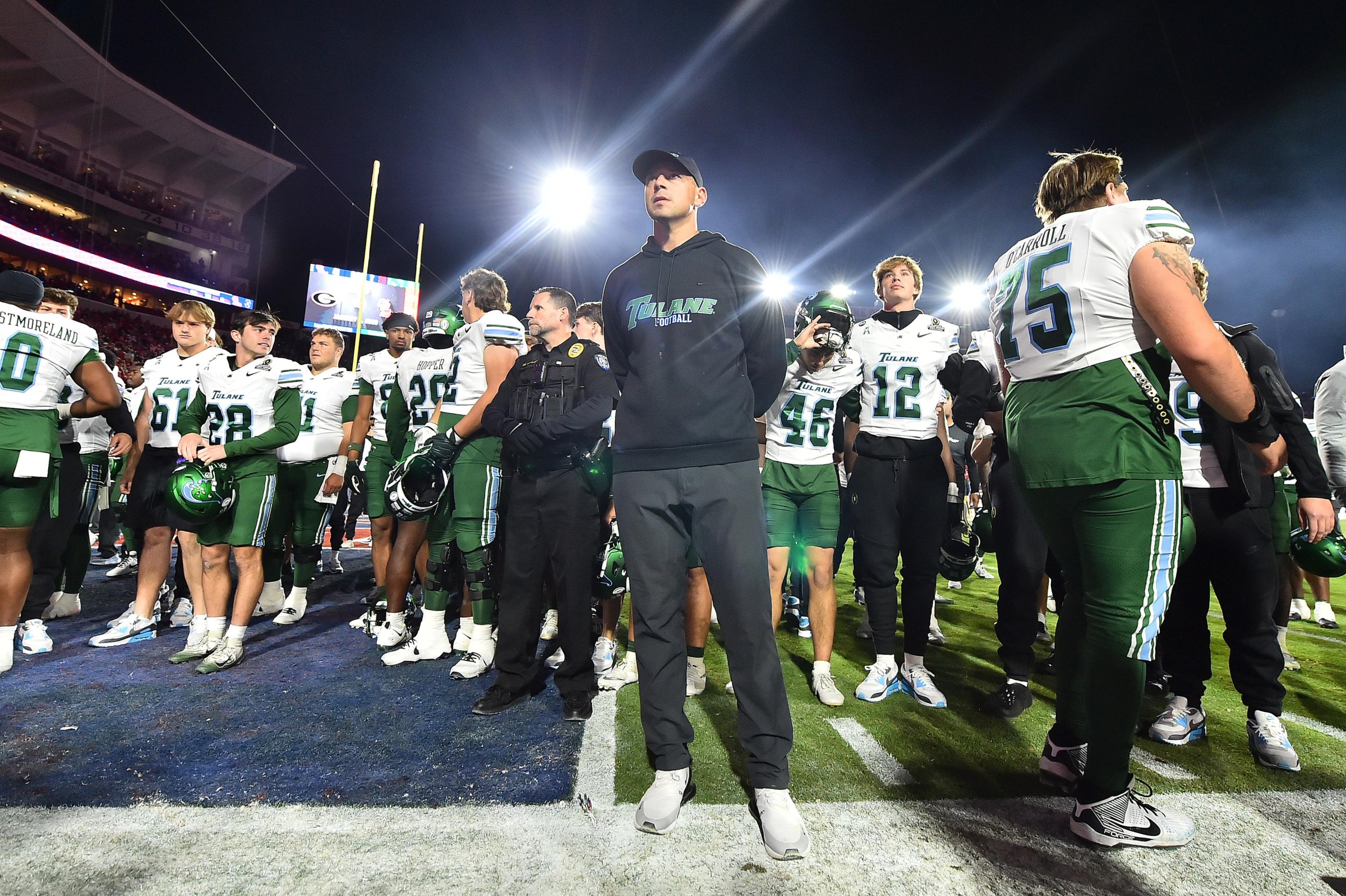 OXFORD, MISSISSIPPI - DECEMBER 20: Head coach Jon Sumrall of the Tulane Green Wave stands with players after a loss to the Ole Miss Rebels during the 2025 College Football Playoff First Round Game at Vaught-Hemingway Stadium on December 20, 2025 in Oxford, Mississippi. (Photo by Justin Ford/Getty Images)