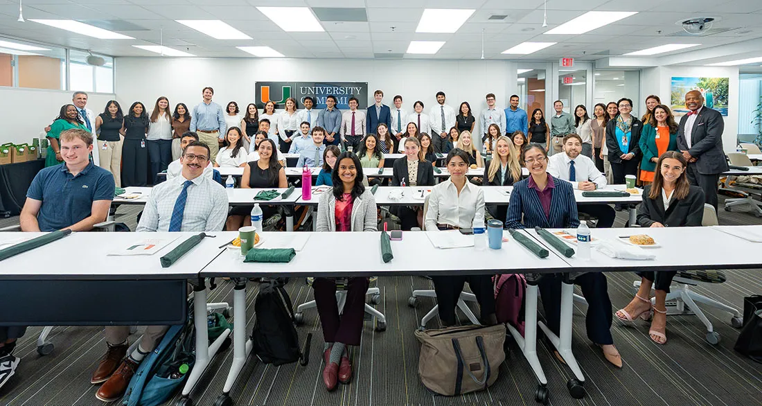 Group photo of the University of Miami Miller School of Medicine M.D./M.P.H. Class of 2030 during orientation, with students and faculty seated and standing in a classroom.
