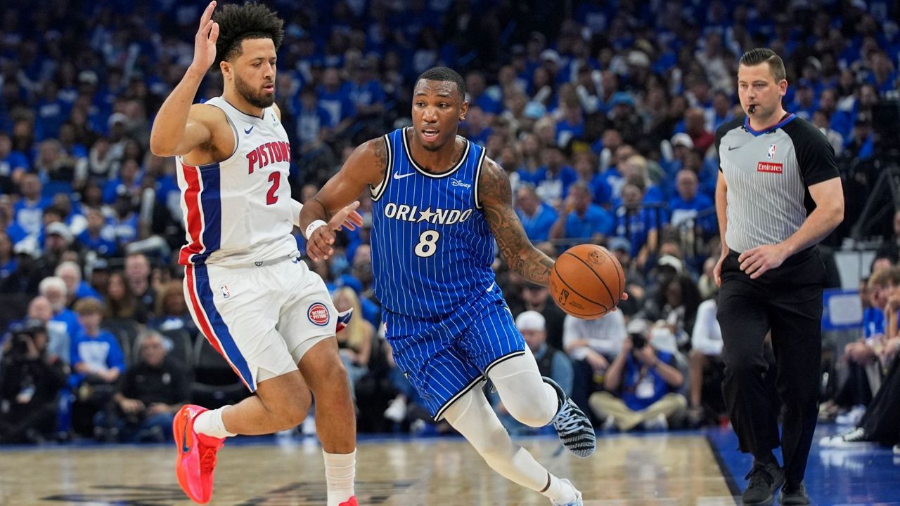 Magic forward Jamal Cain (8) drives around Pistons guard Cade Cunningham (2) on April 27, 2026 during Game 4 of the teams' first-round NBA playoff series. (AP Photo/John Raoux)