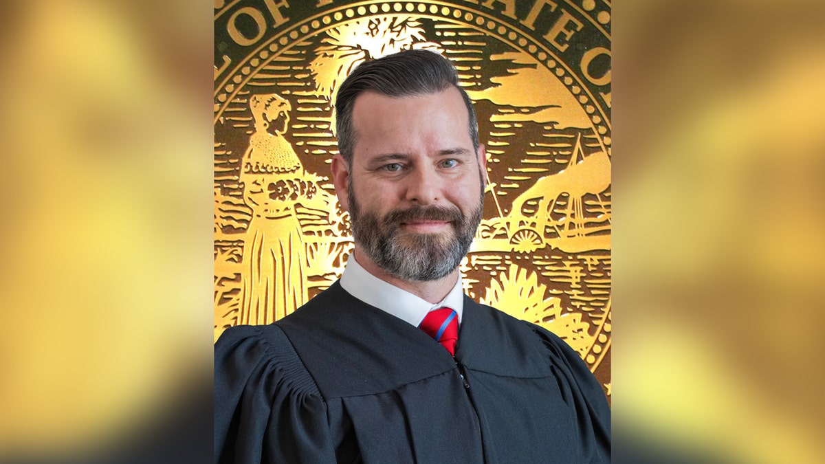 Judge Jason Reding Quiñones standing in front of a Florida court building