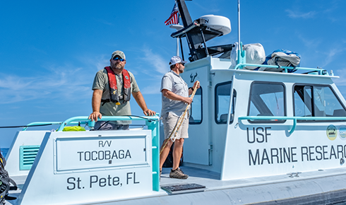 Jay Law and Ben Meister look out from the Tocobaga’s starboard.