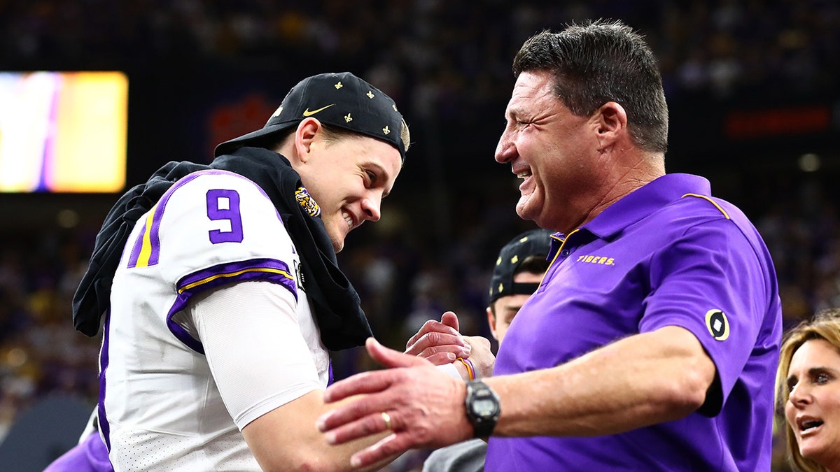 LSU Tigers head coach Ed Orgeron celebrating with quarterback Joe Burrow at Mercedes-Benz Superdome