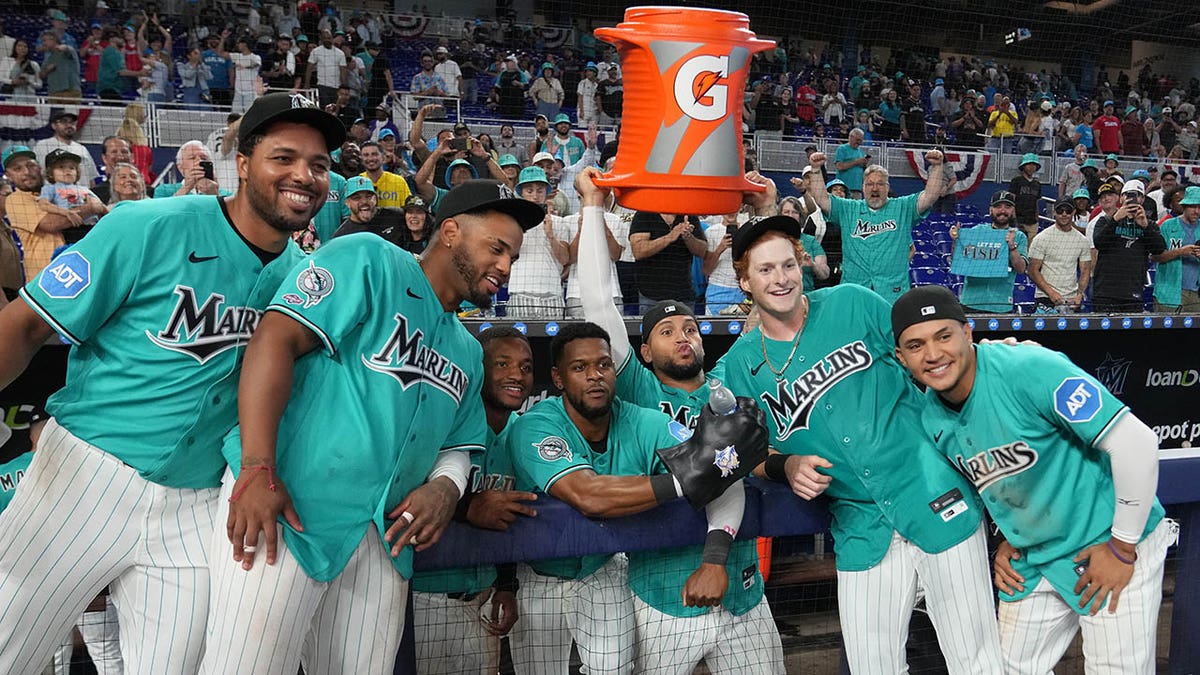 Owen Caissie celebrating with Miami Marlins teammates after a walk-off home run