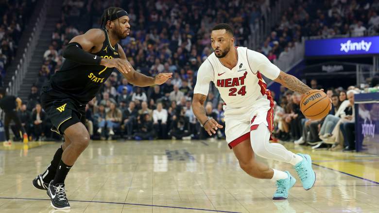 Miami Heat guard Norman Powell drives against veteran guard Buddy Hield during an NBA game.