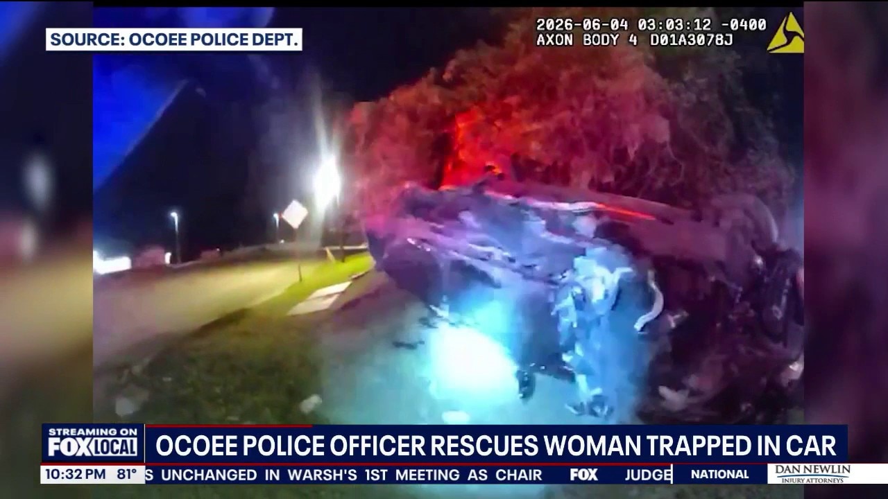 Officer rescues woman trapped in overturned vehicle after crash