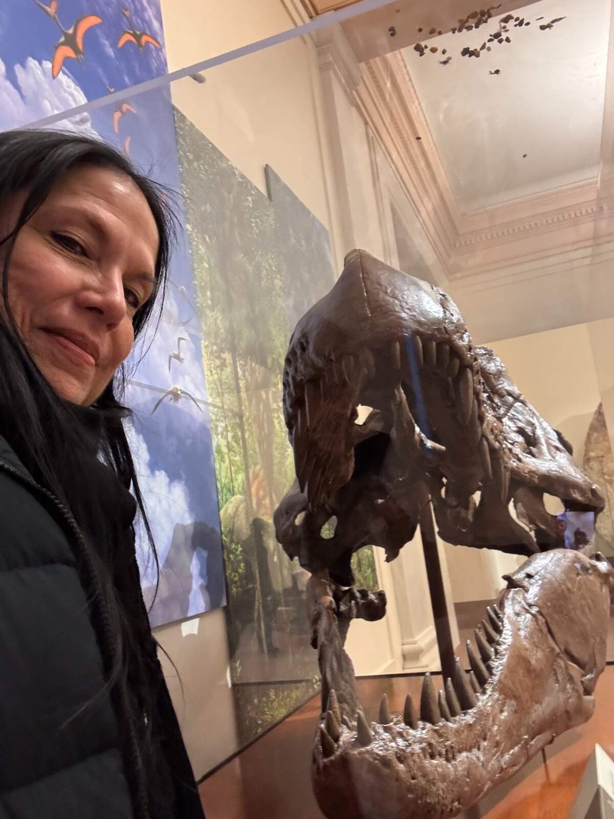Tina Osceola, historic preservation officer and executive director of operations for the Seminole Tribe of Florida, poses with the fossils of extinct prehistoric animals during a visit to the Smithsonian’s National Museum of Natural History.