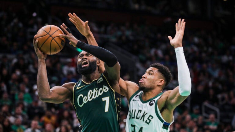 Boston Celtics guard Jaylen Brown (7) is fouled by Milwaukee Bucks forward Giannis Antetokounmpo (34) during third quarter of Sunday’s game on Christmas at TD Garden.