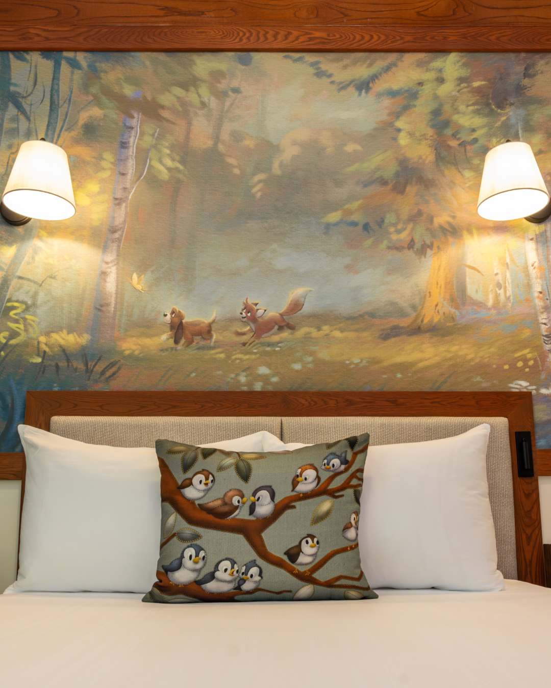 A mural was also displayed that shows Todd and Copper from The Fox and the Hound running through a forest. Though the birds shown on the pillow on the bed in front of the mural more closely resemble those from Cinderella rather than Fox and the Hound.
