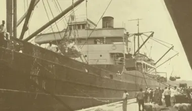 A ship on Jacksonville's working waterfront in a sepia-toned historic photo.