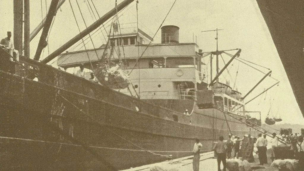 A ship on Jacksonville's working waterfront in a sepia-toned historic photo.