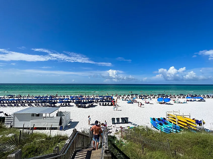 People relaxing along the sandy beach in WaterColor, Florida