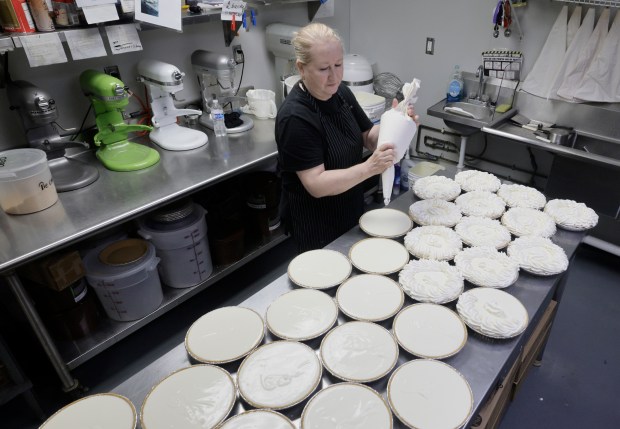Alla Golbraykh puts the finishing touches on Key lime pies at Bob Roth's New River Groves on Thursday, June 18, 2026. (Mike Stocker/South Florida Sun Sentinel)