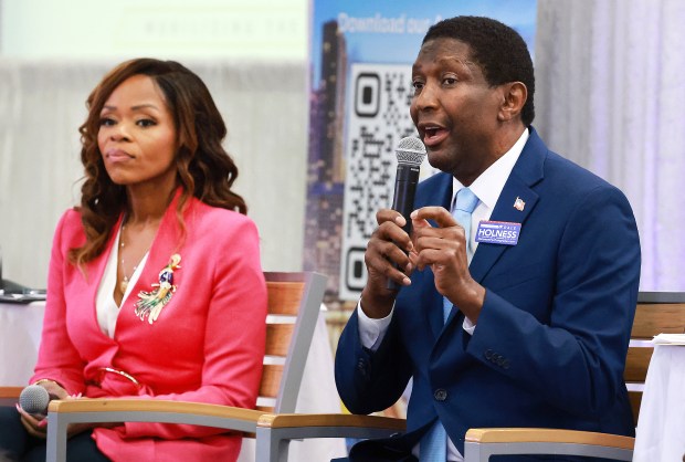 Former Congresswoman Sheila Cherfilus-McCormick, listens as former Broward County Commissioner Dale Holness speaks during the 20th Congressional District candidate forum at the Urban League of Broward County in Fort Lauderdale on Wednesday, June 17, 2026. (Carline Jean/South Florida Sun Sentinel)