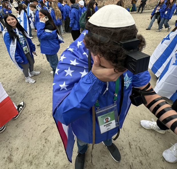 Daniel Oren, 18, wraps Tefillin during the March of the Living 2026. (Oren/Courtesy)