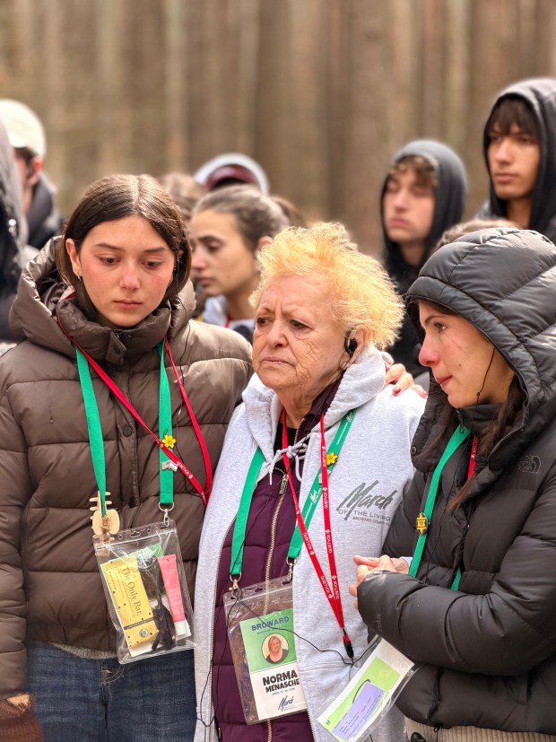 Broward County students comfort Norma Menasche, a Holocaust survivor, during the March of the Living. (March of the Living/Courtesy)
