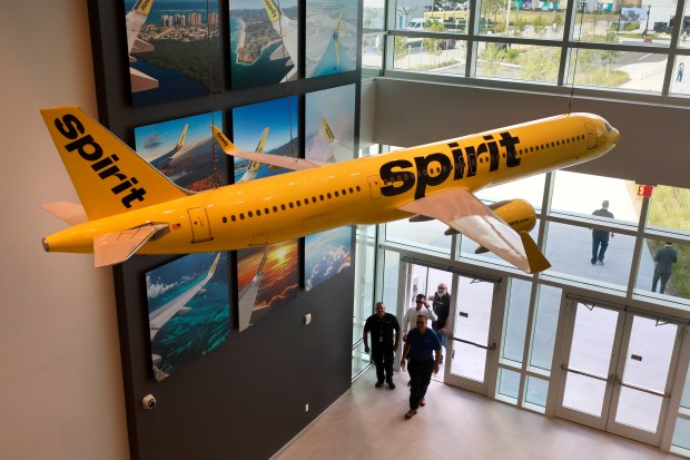 People walk into the new crew training facility built for hands-on experience in flight simulators. An opening ceremony was held for the new Spirit Airlines Central Campus in Dania Beach on Thursday, April 18, 2024. The campus spans more than 11 acres and features four buildings, including a support center with offices, an amenity building, a new crew training facility built for hands-on experience in flight simulators, and a corporate housing facility. (Mike Stocker/South Florida Sun Sentinel)