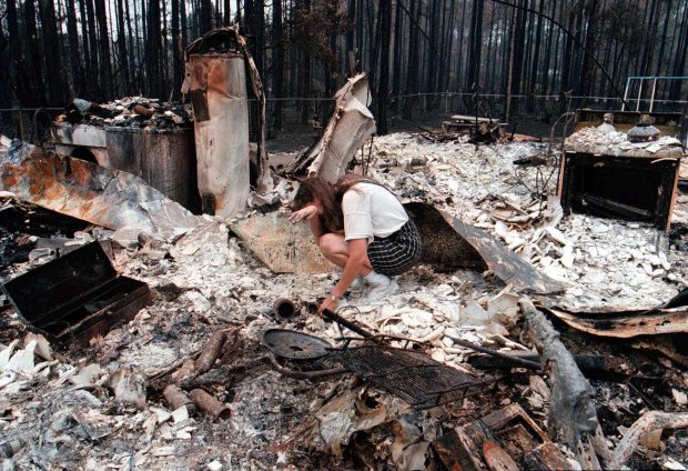 Amber Jorgensen kneels and cries in the rubble of her home in the Mantanzas Woods neighborhood of Palm Coast, Fla., on July 6, 1998. Her family lost their entire home to the central Florida wildfires. (Orlando Sentinel file)