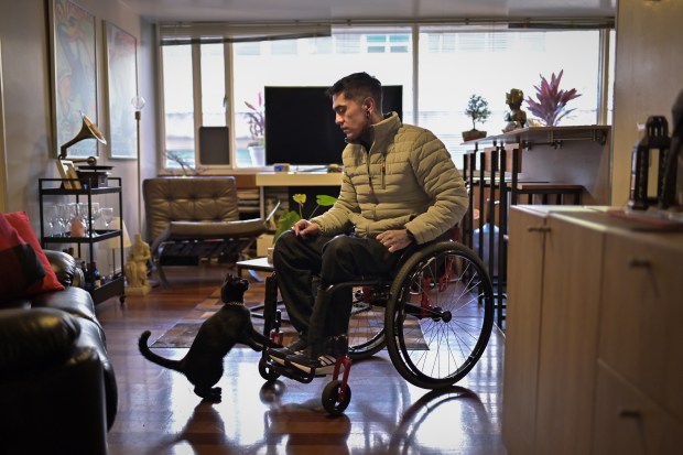 Pulse survivor Juan José Cufiño Rodriguez - pictured with his cat, Conchita, at his apartment in Bogotá, Colombia - is glad the city finally tore down the nightclub but does not plan to visit the memorial to be built there. (Luis Angel for the Orlando Sentinel)