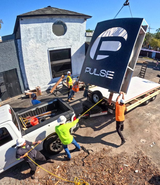 The sign for the Pulse nightclub is removed by workers on March 11, 2026. It will be preserved and displayed at the permanent memorial, slated to open in fall of 2027. (Joe Burbank/Orlando Sentinel)
