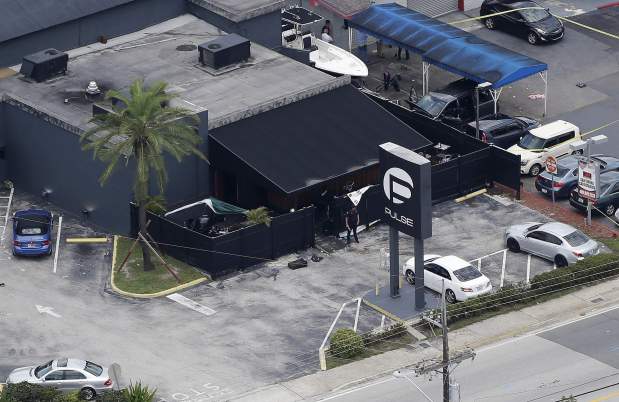 In this June 12, 2016 file photo, law enforcement officials work at the Pulse nightclub following the mass shooting. (Chris O'Meara/AP file)