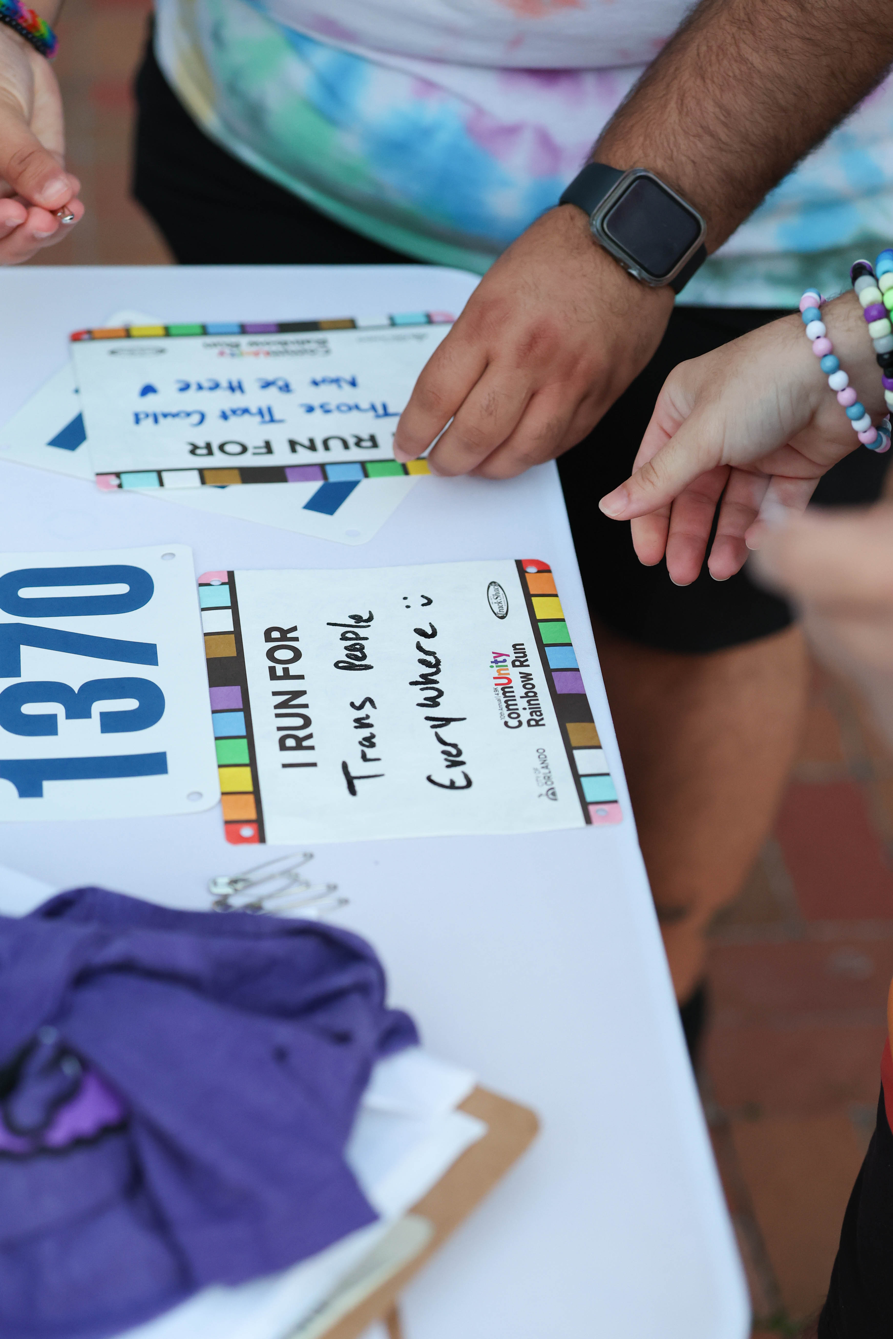 Runners get their race bibs and dedications ready during the...