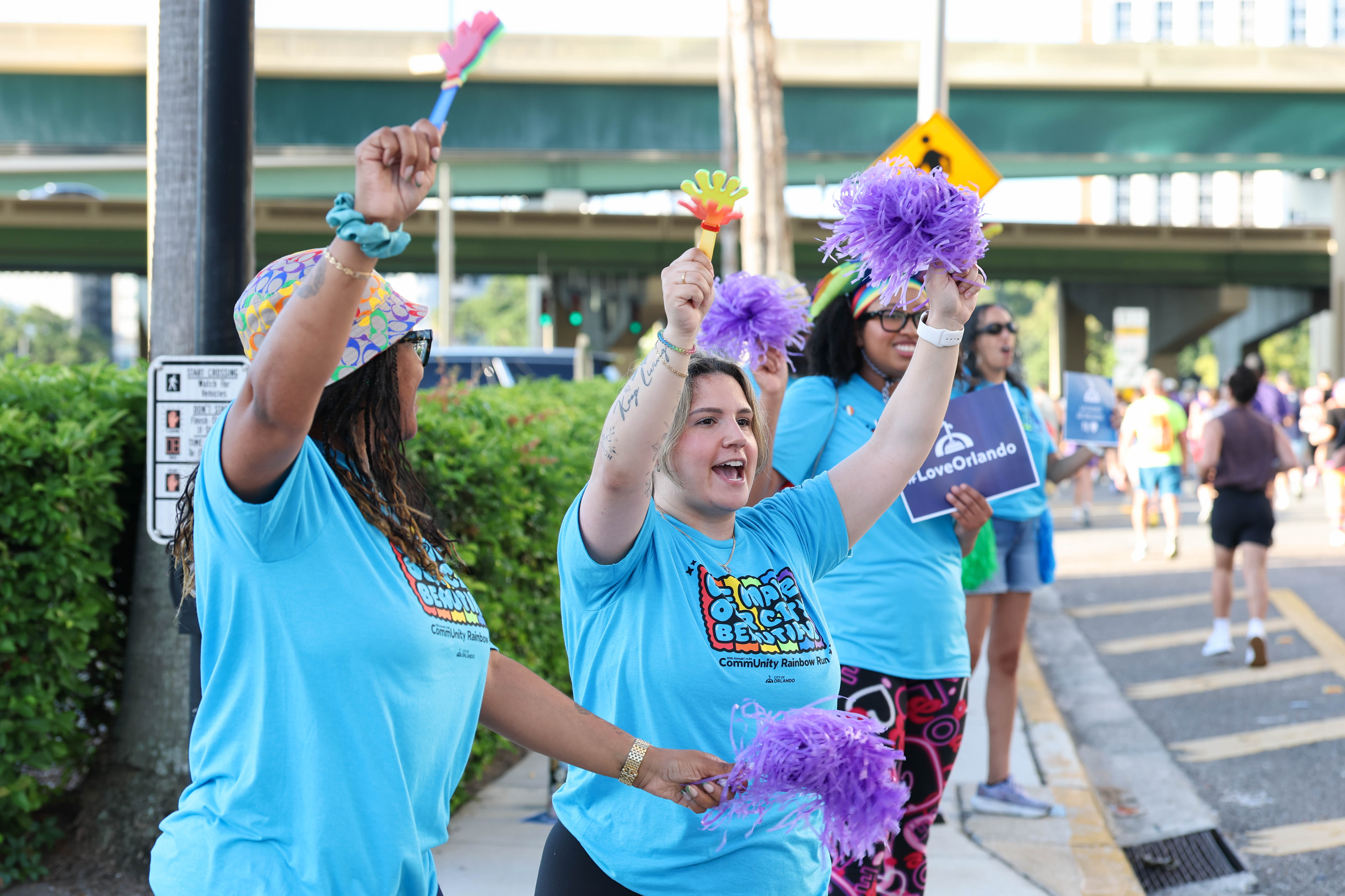 Volunteer cheerleaders celebrate the runners during 10th Annual CommUNITY Rainbow...