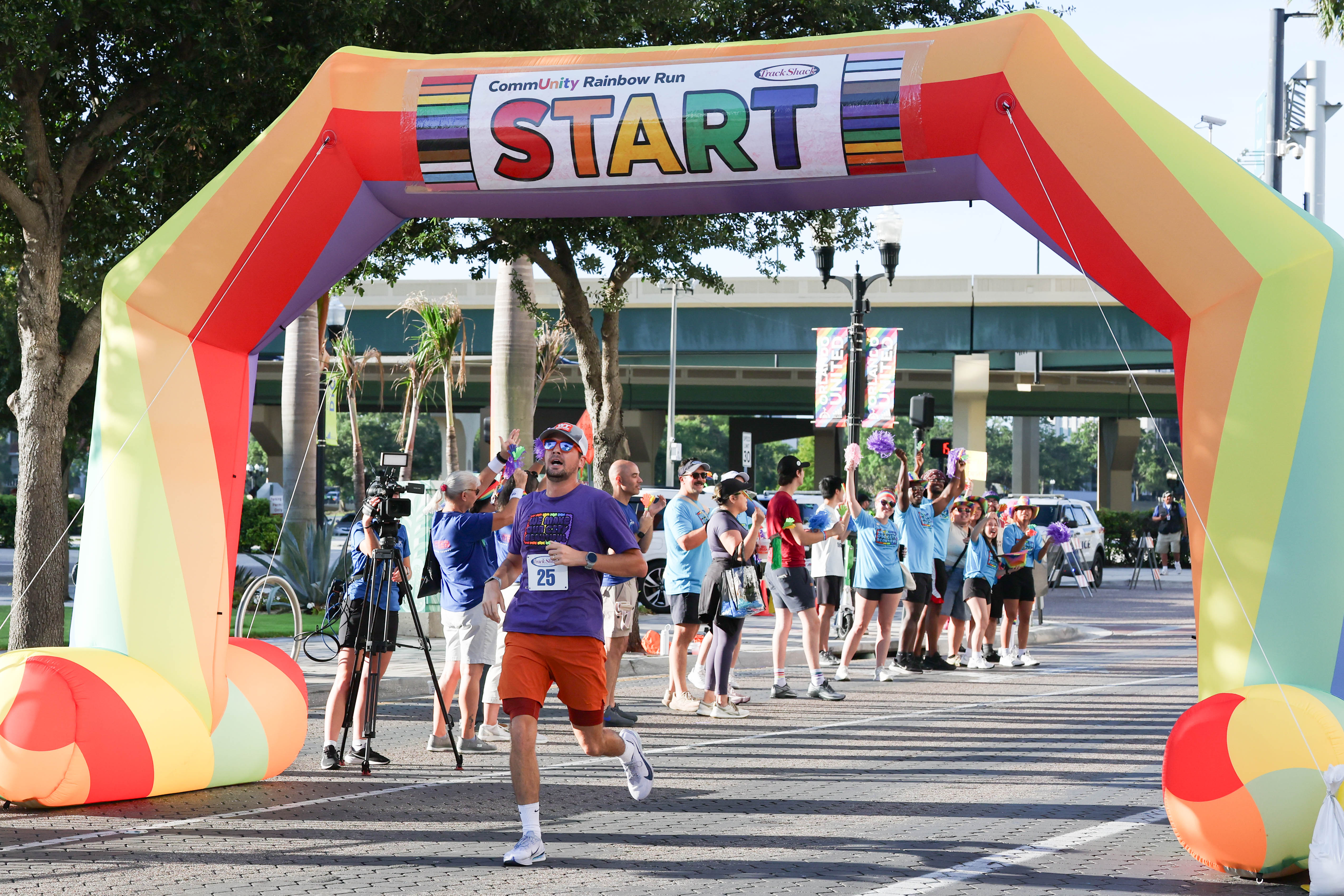 First place runner Tommy Amato crosses the finish line during...