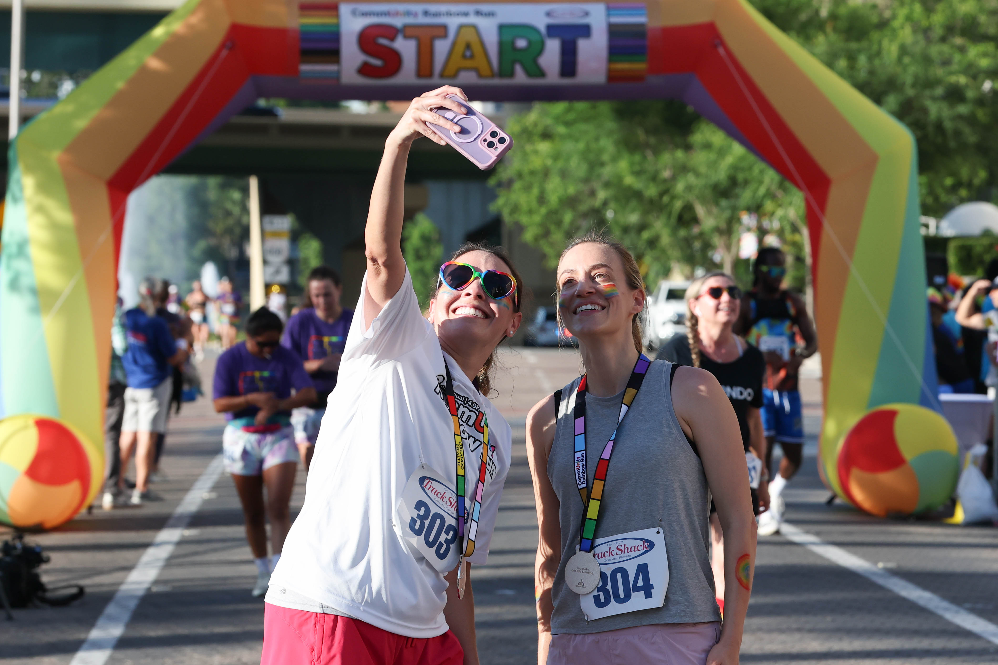Runners celebrate their finish with a selfie during the 10th...