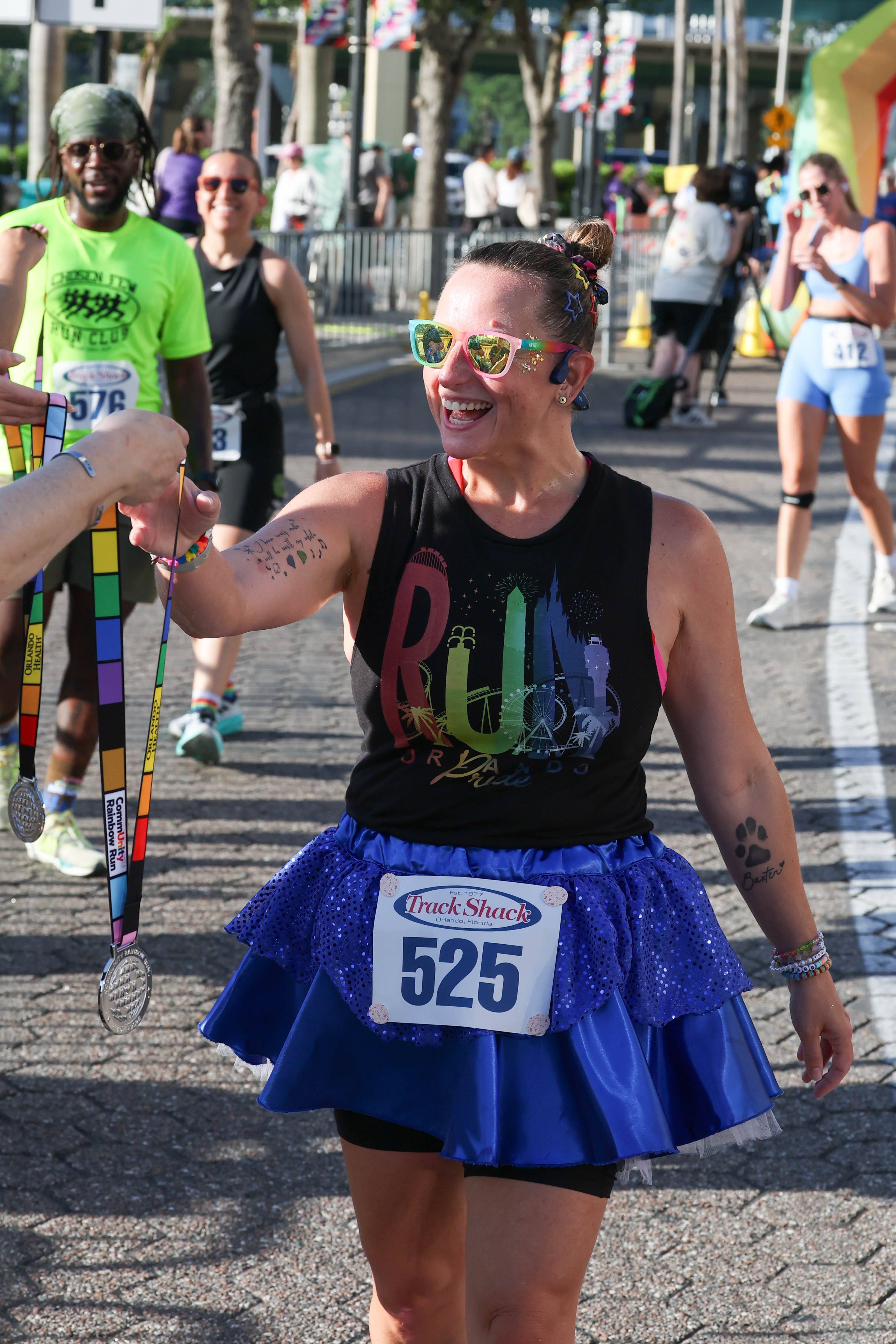 Runner receives her medal during the 10th Annual CommUNITY Rainbow...
