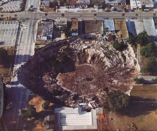 Aerial view of the Winter Park sinkhole, which occurred on May 9, 1981. The huge crater sucked up the home of Mae Rose Williams, five Porsches from an adjacent car lot and the deep end of the city's swimming pool. (Orlando Sentinel file)