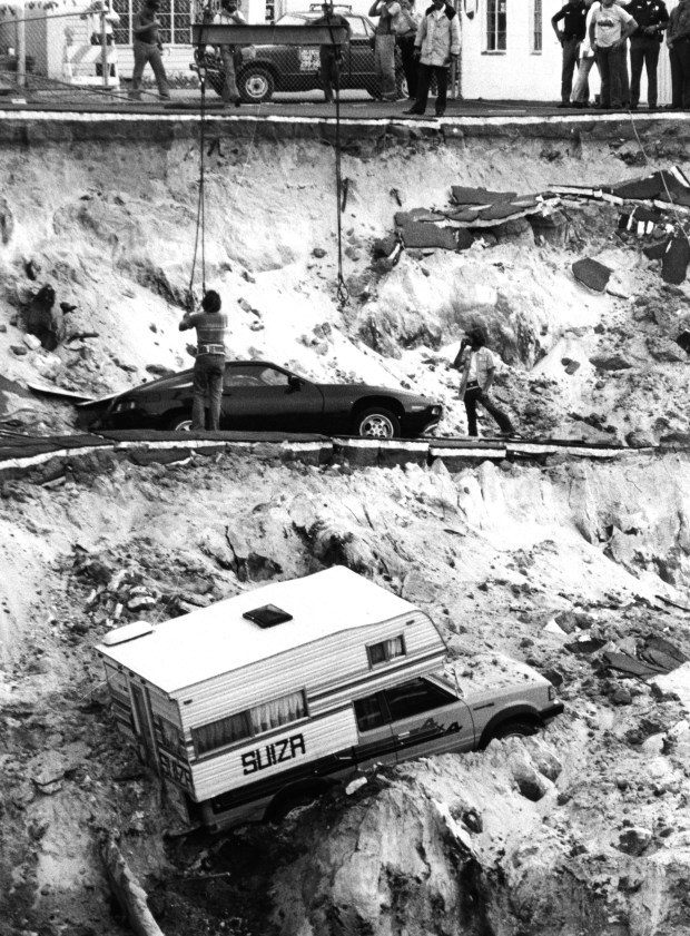 In 1981, a sinkhole in Winter Park opened up gulping down 250,000 cubic yards of soil, five Porsches at a foreign car repair shop, the deep end of an Olympic-size swimming pool, chunks of two streets and a three-bedroom home. A salvage crew attempts to pull a Porsche from the sinkhole on May 15, 1981. (Orlando Sentinel file)
