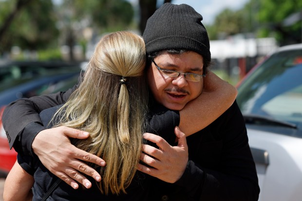 Lisa Barfield hugs Izzy Aly, as he arrives at the Orlando Amtrak Station, on Monday, June 22, 2026. Aly was detained by ICE in Pennsylvania, and returned to Florida after being released. (Ricardo Ramirez Buxeda/ Orlando Sentinel)