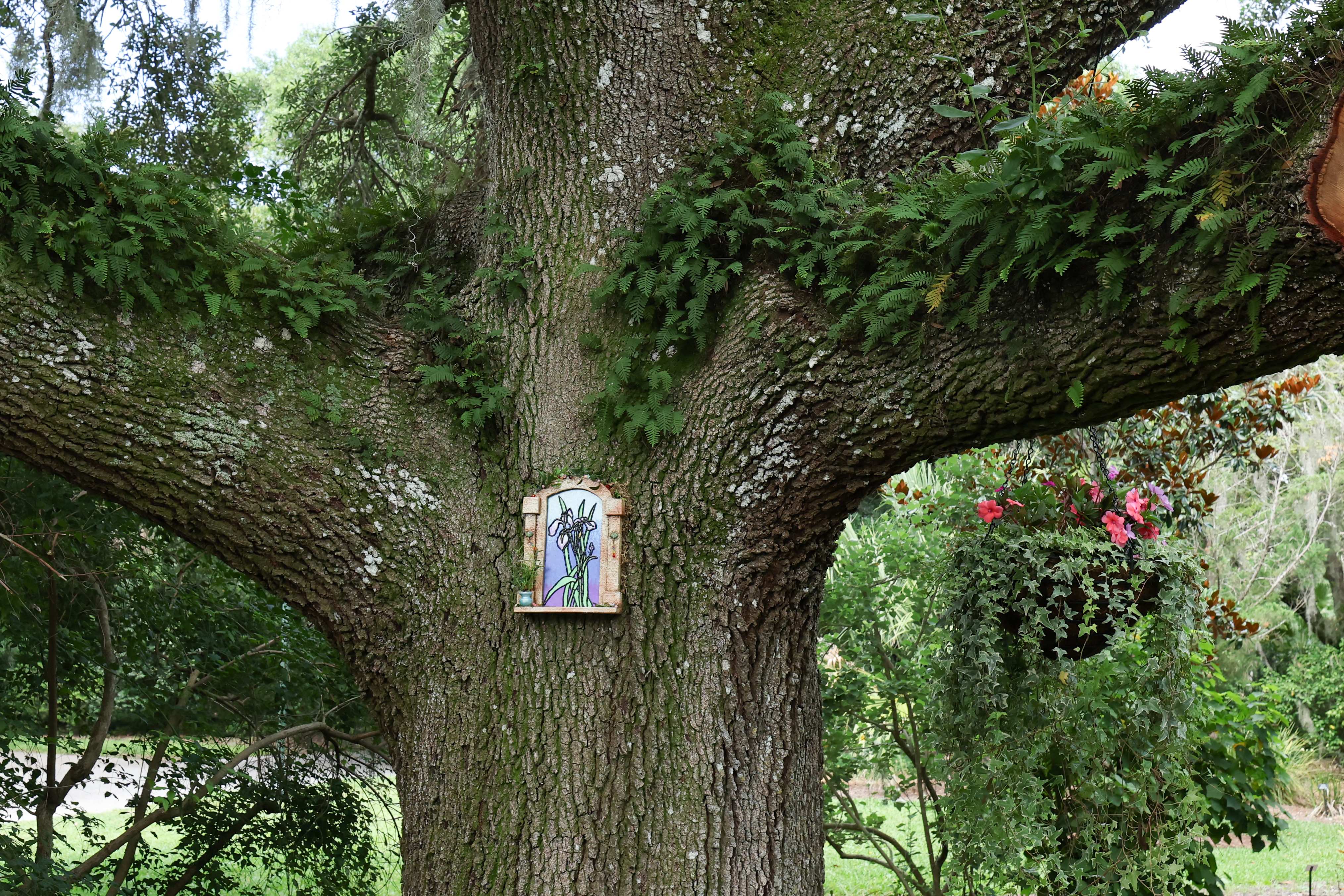 Flower fairy Irisâs door among the plants and trees at...