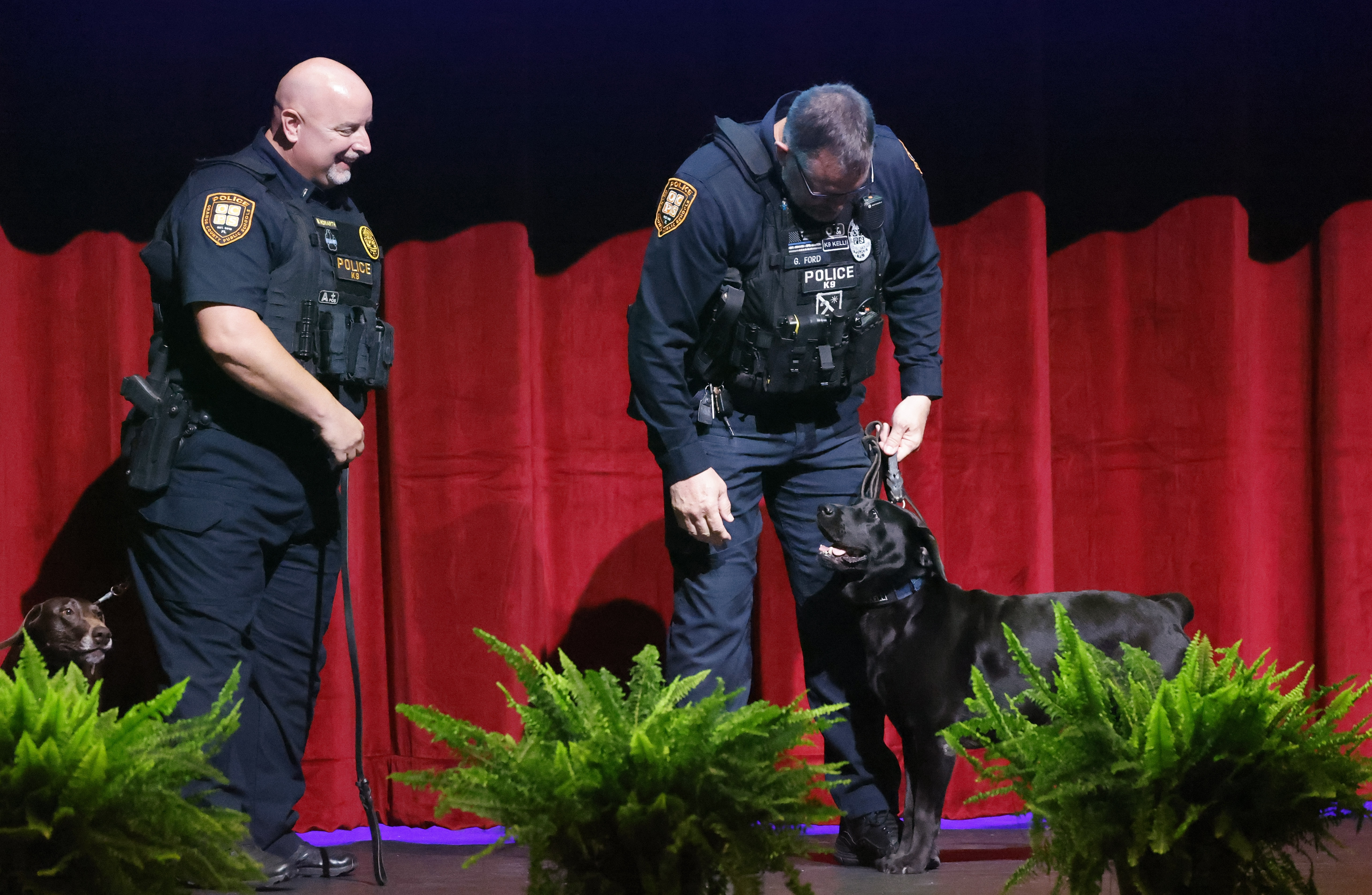 OCPS Officer Brian Howarth with K-9 Coco, on left, and...