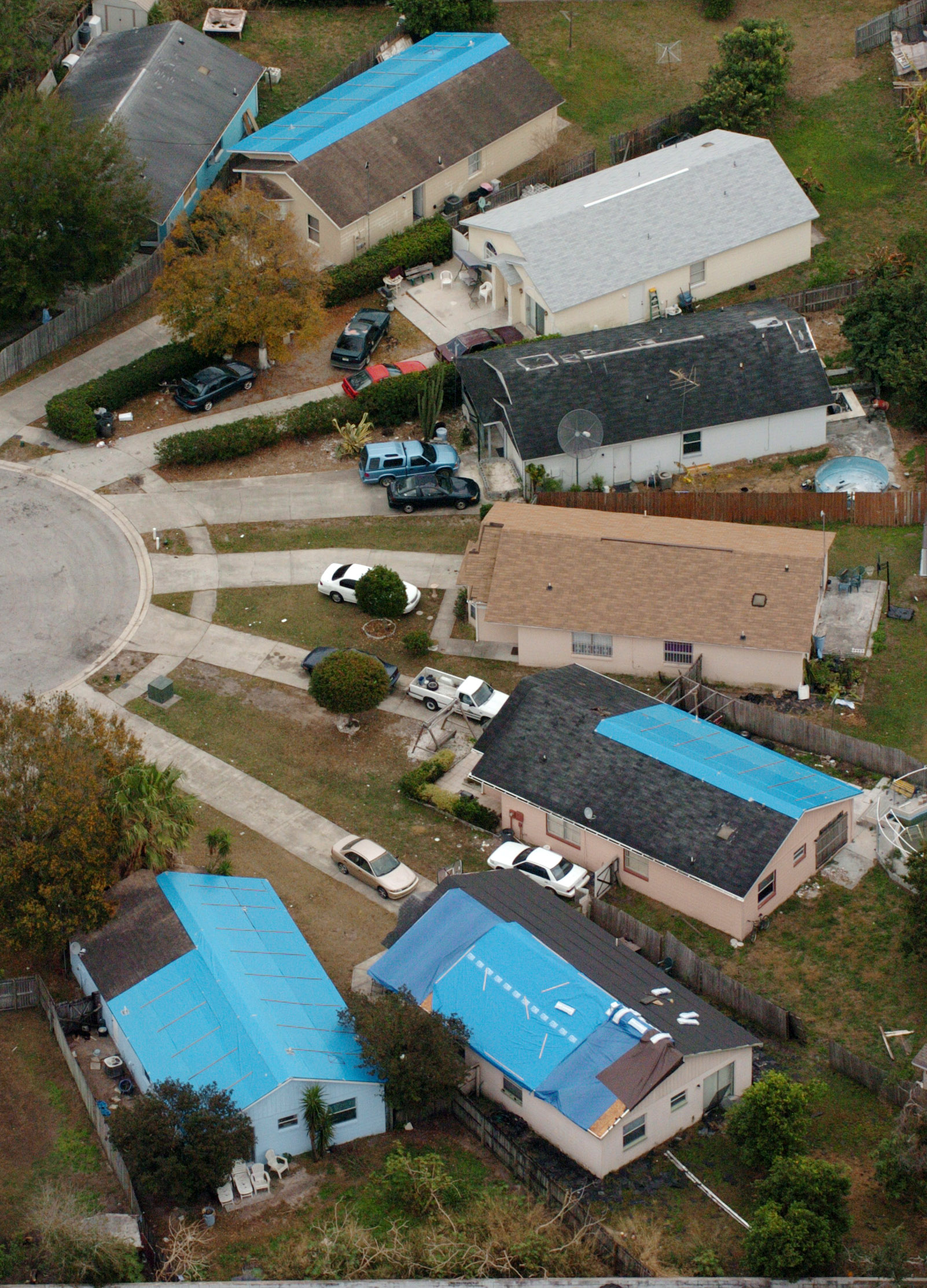 Blue tarps still cover roofs in February 2005 that were...