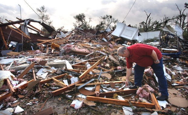 The pastor of the Lady Lake Church of God, Larry Lynn, picks through the rubble after the church was destroyed by a tornado on Feb. 2, 2007. (Joe Burbank/Orlando Sentinel file) 