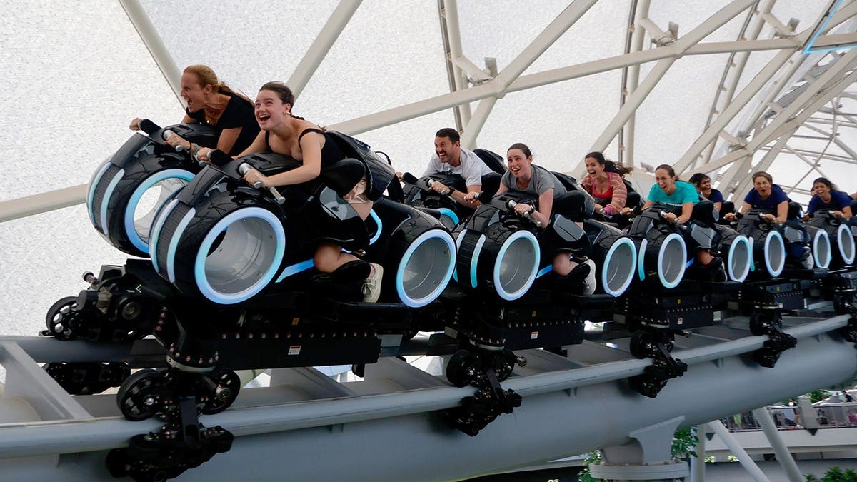 People riding the Tron Lightcycle rollercoaster at Magic Kingdom Park in Orlando