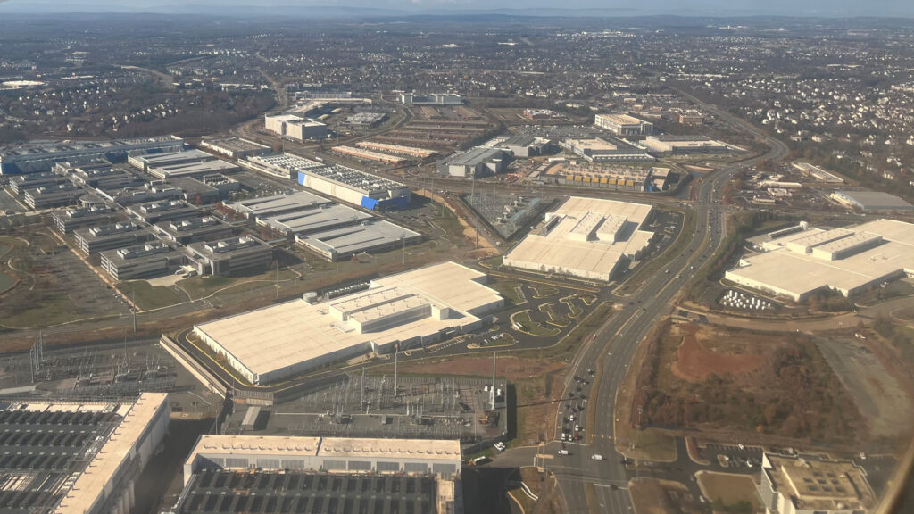 An aerial view of data centers intermingled with other commercial buildings in Loudoun County, Virginia (Theodore Christopher, CC0, via Wikimedia Commons)