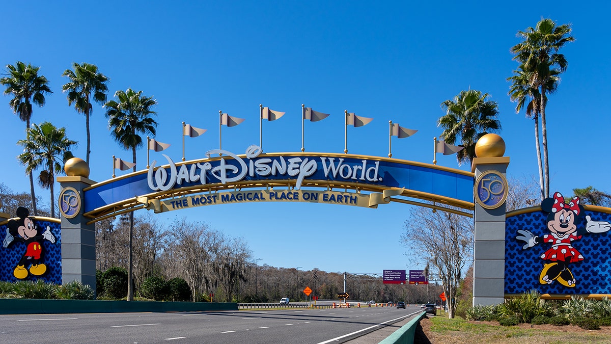 Walt Disney World entrance arch gate with Mickey and Minnie Mouse in Orlando Florida