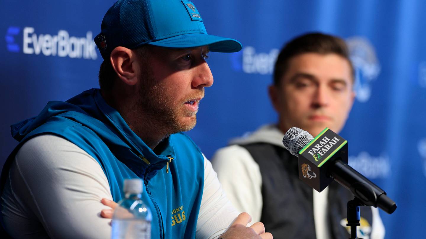 Jacksonville Jaguars head coach Liam Coen speaks during a press conference as general manager James Gladstone looks on at the Miller Electric Center, Wednesday, Jan. 14, 2026, in Jacksonville, Fla.