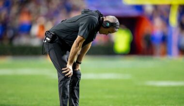 Florida State Seminoles head coach Mike Norvell holds his head between his legs during the second half against the Florida Gators at Steve Spurrier Field at Ben Hill Griffin Stadium in Gainesville, FL on Saturday, November 25, 2023. [Matt Pendleton/Gainesville Sun]