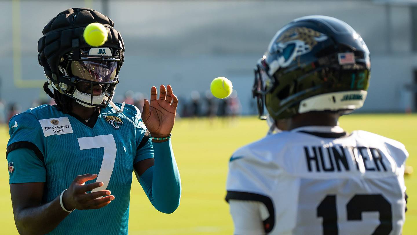 Jacksonville Jaguars wide receiver Brian Thomas Jr. (7) and Jacksonville Jaguars wide receiver Travis Hunter (12) use tennis balls in a drill during an NFL training camp fourth session at the Miller Electric Center, Sunday, July 27, 2025, in Jacksonville, Fla. [Doug Engle/Florida Times-Union]