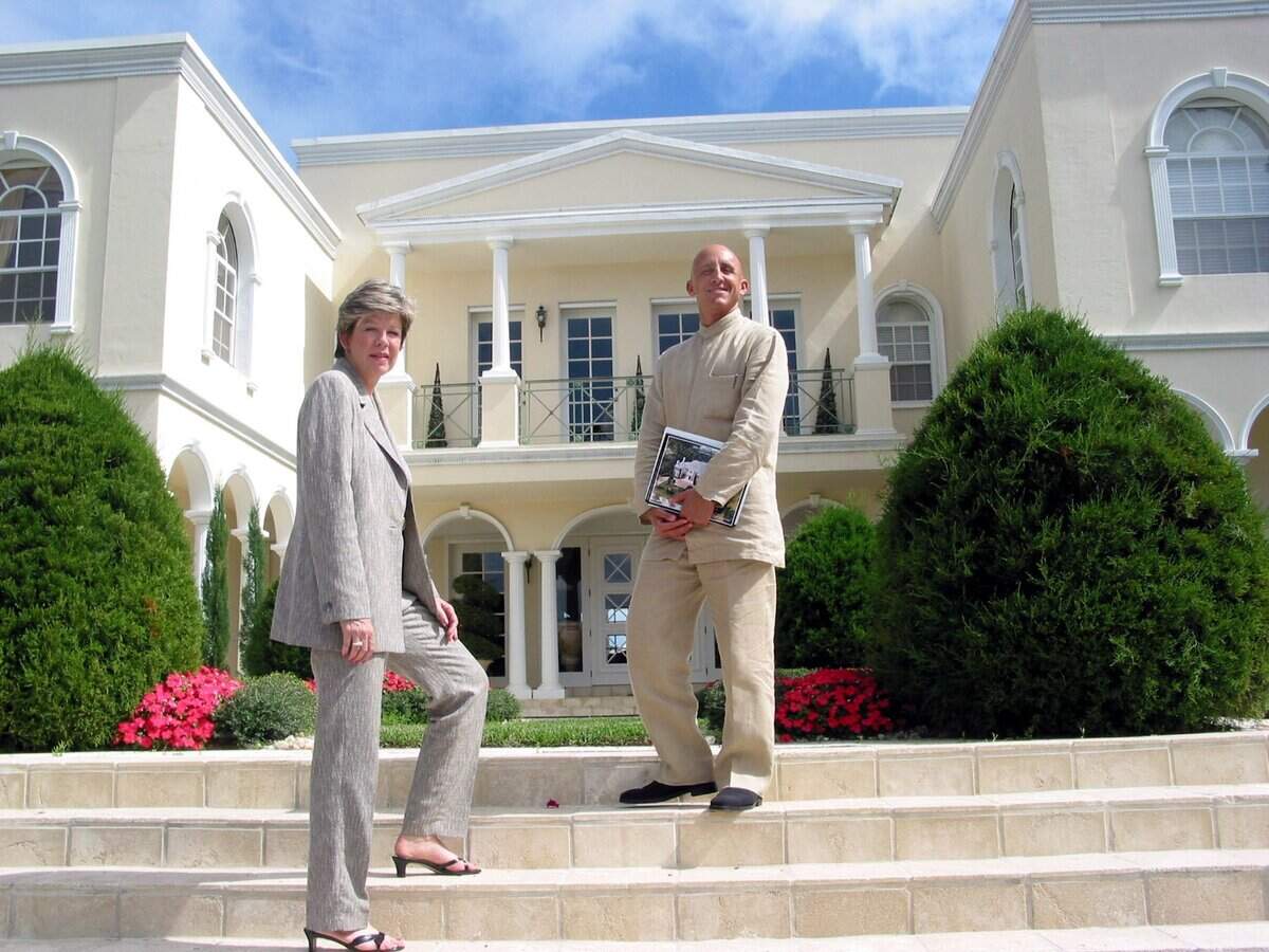 In this 2003 file photo, Coldwell Banker’s Pat Dahne and Carlos Justo in front of an Indian Creek Village home.