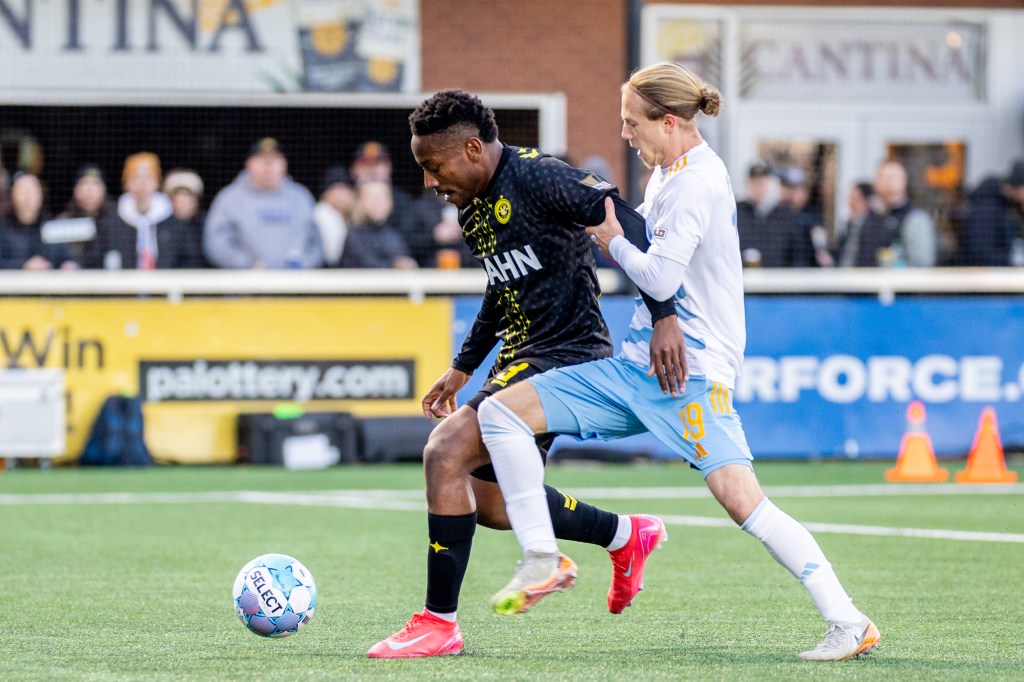 Perrin Barnes holds off Sporting Jacksonville's Rafferty Pedder in the Pittsburgh Riverhounds' 3-2 win on March 28, 2026 at Highmark Stadium in Pittsburgh. (Photo: Chris Cowger/Riverhounds SC)