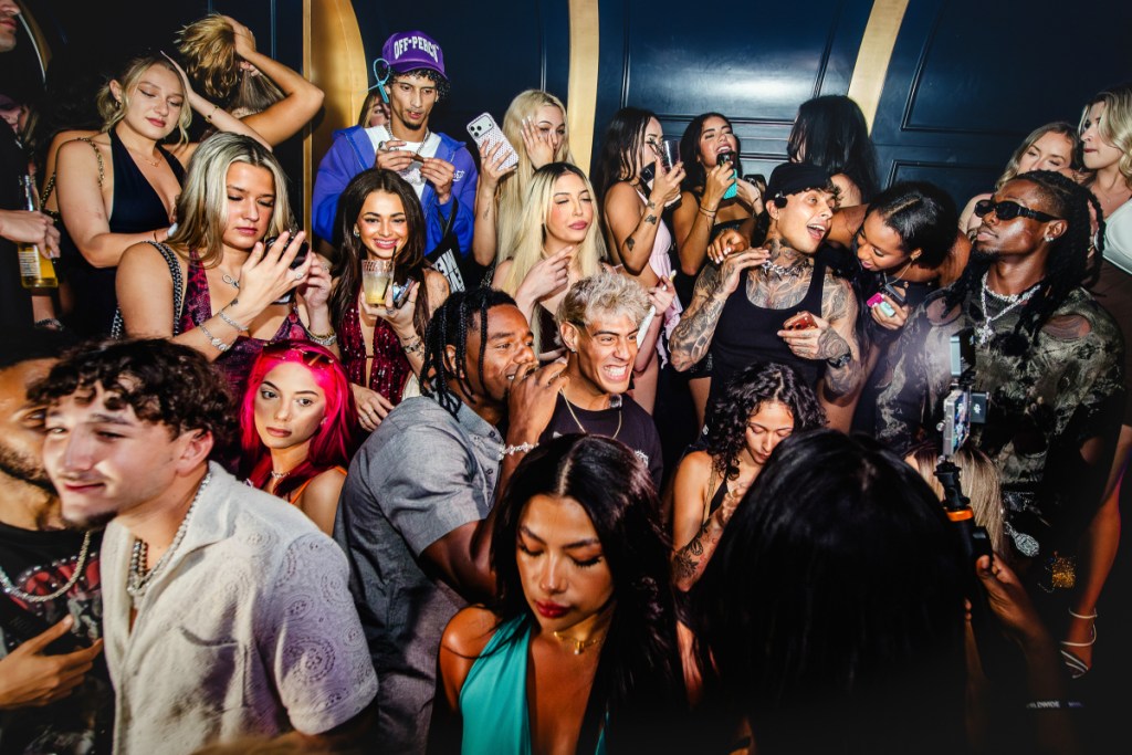 A photo of a group of people inside a nightclub