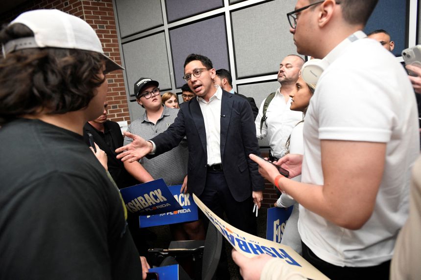 Republican Florida gubernatorial candidate James Fishback talks with college students after giving a campaign speech at the University of Central Florida in Orlando, Florida, on April 23.