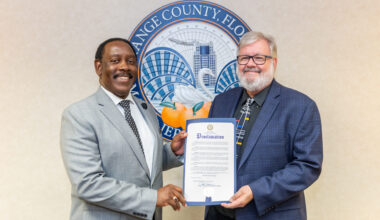 Two men in suits holding a proclamation