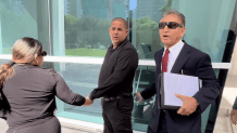 Yusiel Lopez Insua (center) outside court on July 21, 2026.