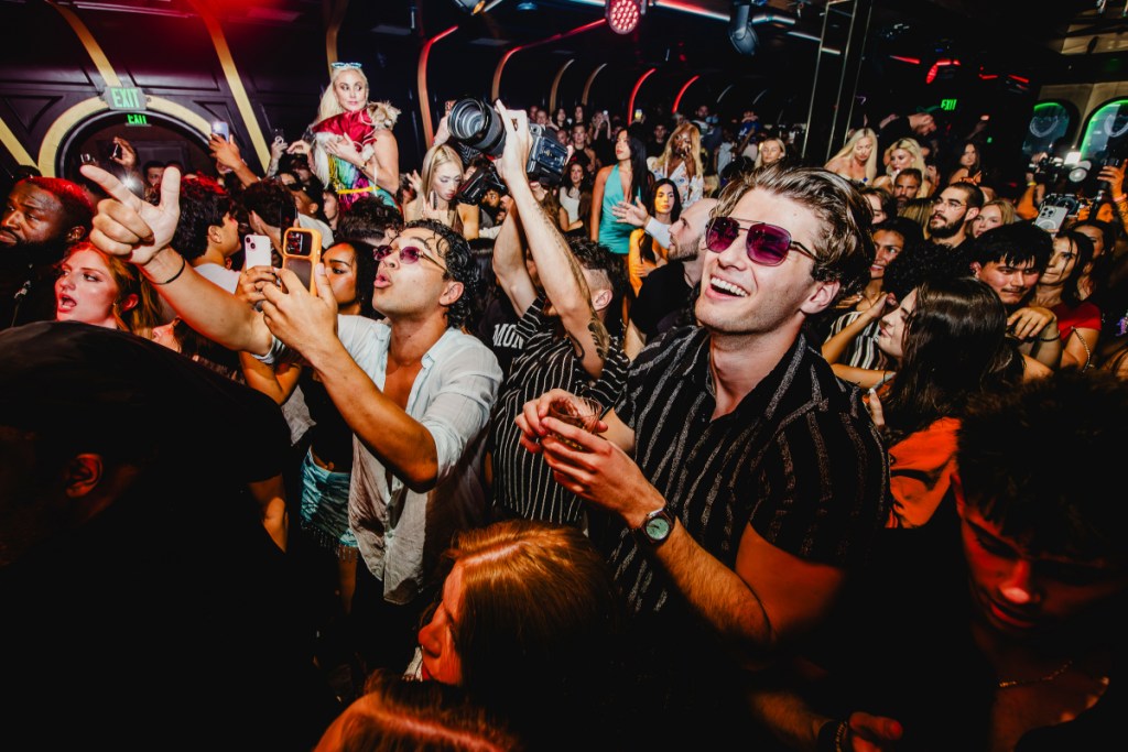 A photo of a group of people inside a nightclub